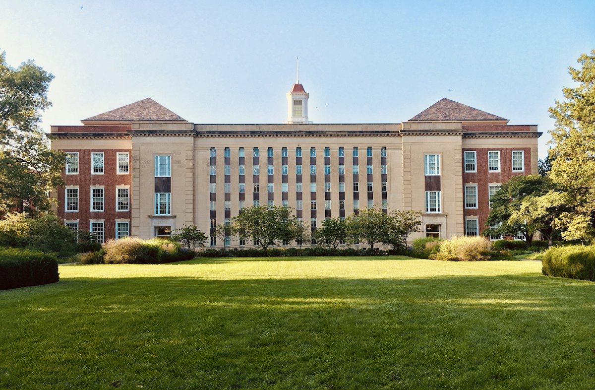 A university building with a lawn in front