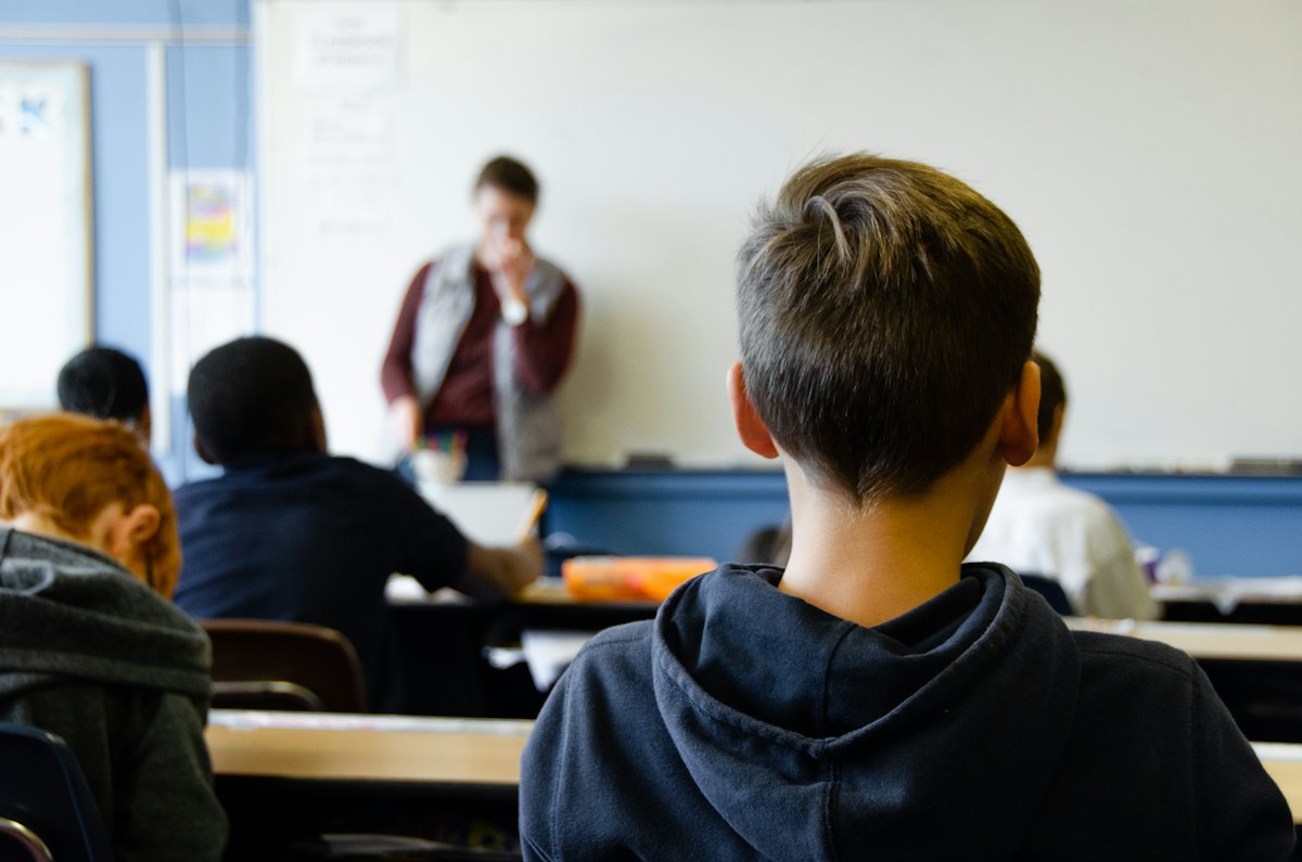 A student looking toward the teacher in a classroom